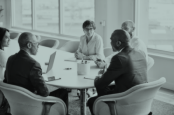 Group of businesspeople in team meeting in office.