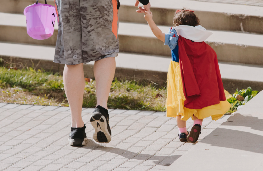 Man trick or treating with his daughter dressed as Snow White