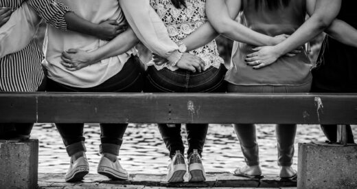 women sitting together on bench