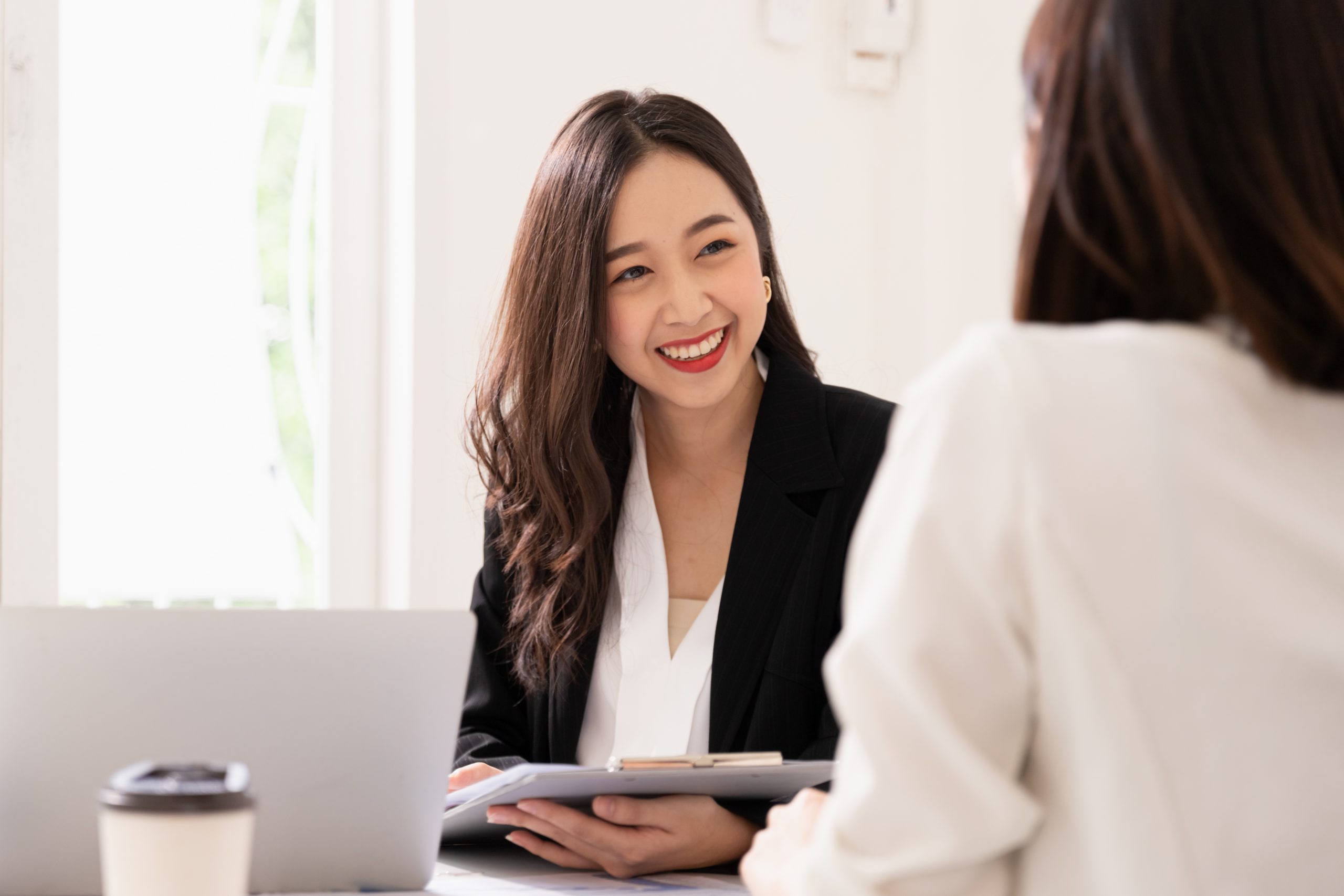A young asian woman is interviewing for a job. Her interviewers are diverse. Human resources manager conducting job interview with applicants in office