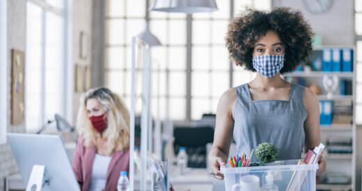 Businesswoman with protective face mask quits job due to limiting workplaces in office, during Covid-19