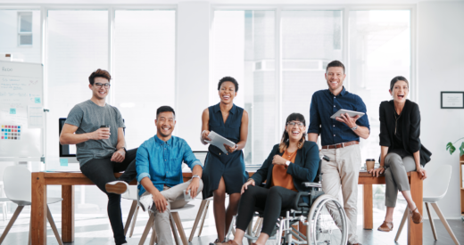 Group of coworkers with and without disabilities smiling together