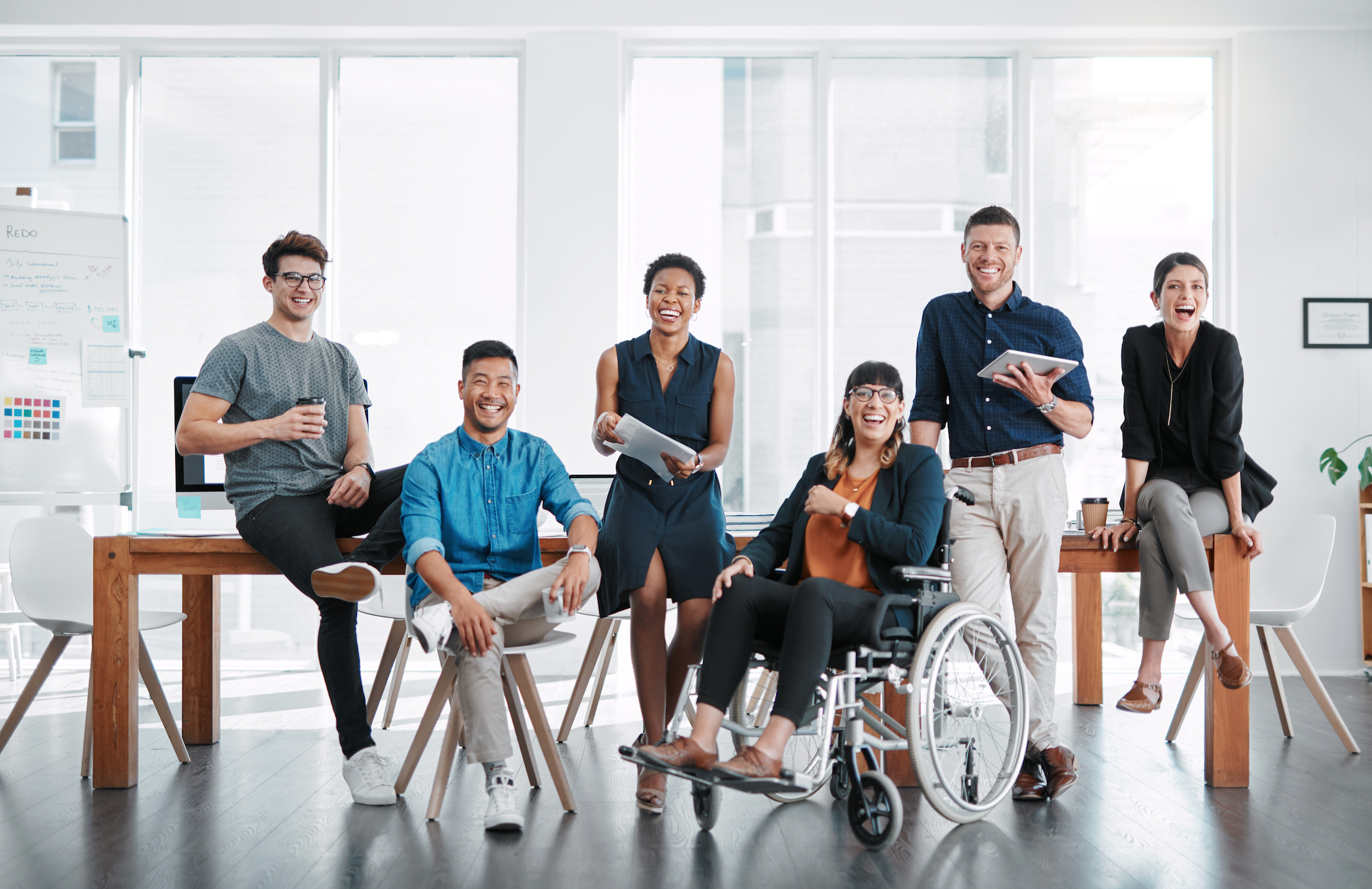 Group of coworkers with and without disabilities smiling together