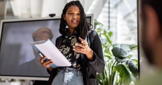 Black woman professional giving a presentation in the workplace