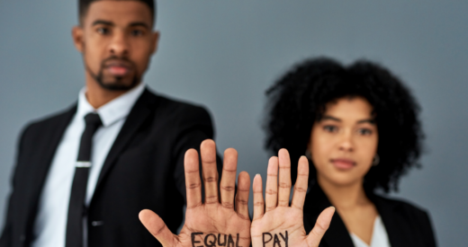 Shot of a businessman and businesswoman advocating for equal pay against a grey studio background