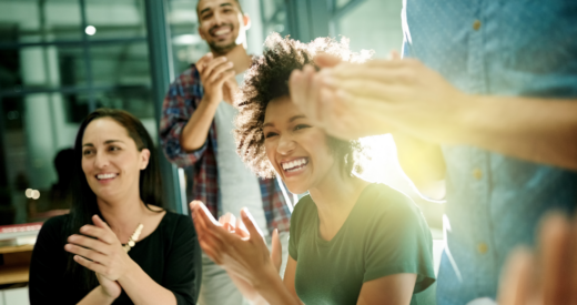 Shot of a team of creative businesspeople applauding an achievement while working late in the boardroom