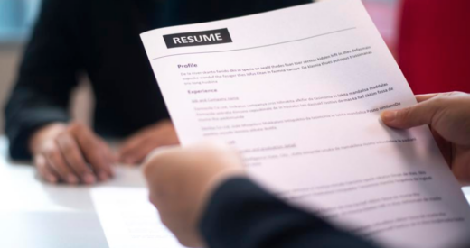 stock image of someone handing over a resume