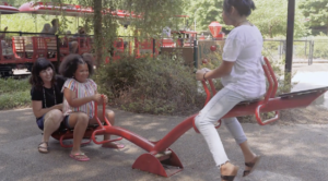 Teri and children playing on seesaw