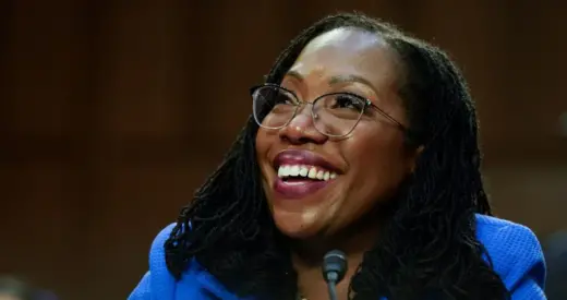 Judge Ketanji Brown Jackson listens to U.S. Senator Cory Booker (D-NJ) speak on the third day of the U.S. Senate Judiciary Committee confirmation hearings on her nomination to the U.S. Supreme Court, on Capitol Hill in Washington, U.S., March 23, 2022.