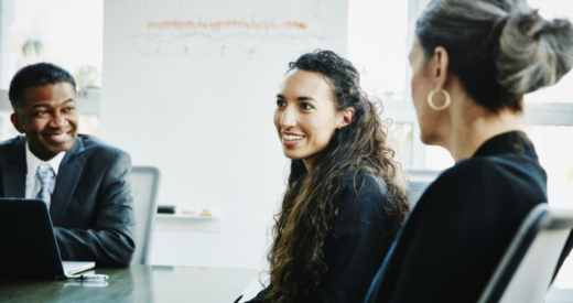 Businesspeople sit around a meeting