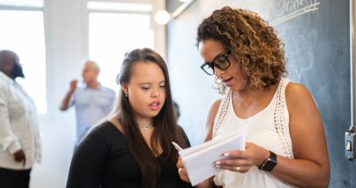 Manager discussing project with woman employee with autism