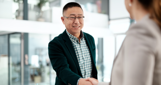 Shot of an older businessman and businesswoman shaking hands in a modern office