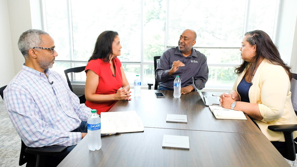 Kurt Merriweather, Melanie Sanders, Donald Thompson, and Jackie Ferguson discuss global DEI around a conference table