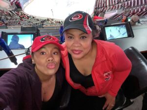 Jackie and Diana smiling together at a Carolina Hurricanes game