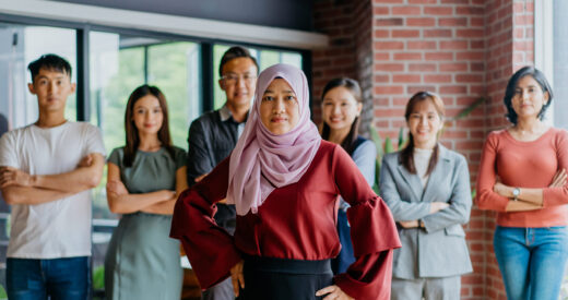Image of confidence Muslim businesswoman and her colleagues. Professional Malaysian business team looking at camera.