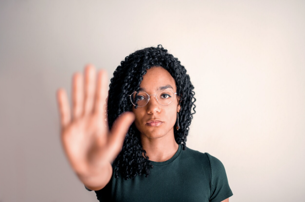 woman holding out her hand in a "stop" motion