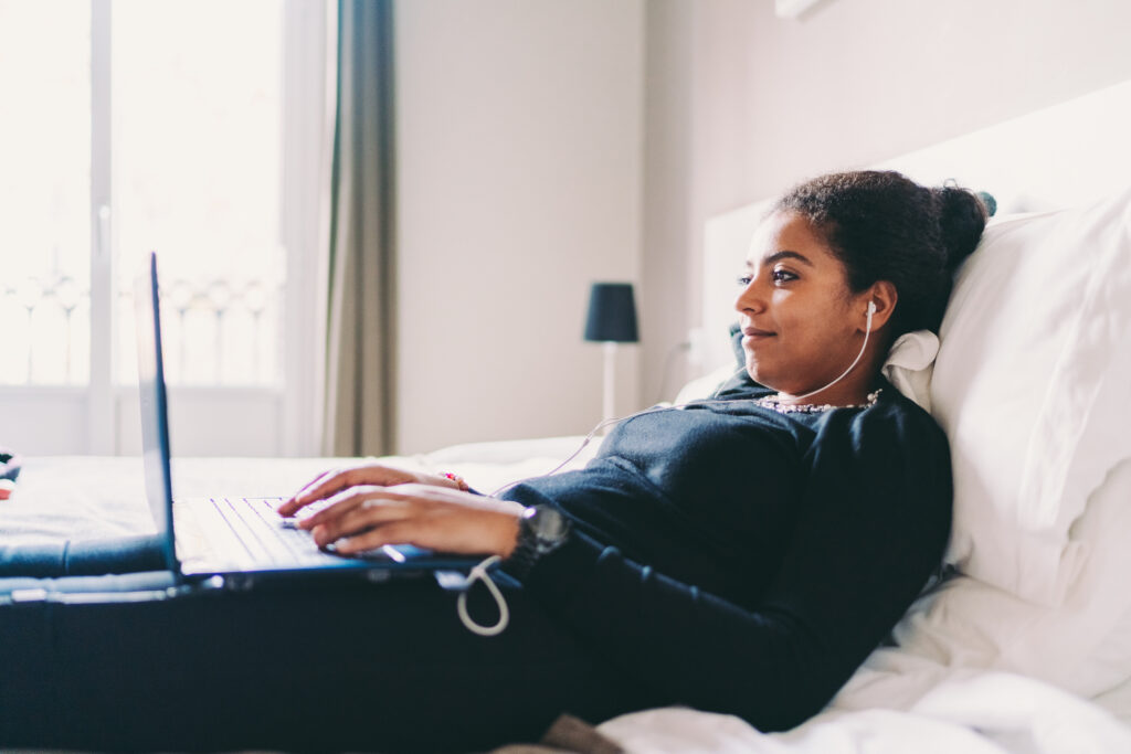 Employee working in bed, telecommuting