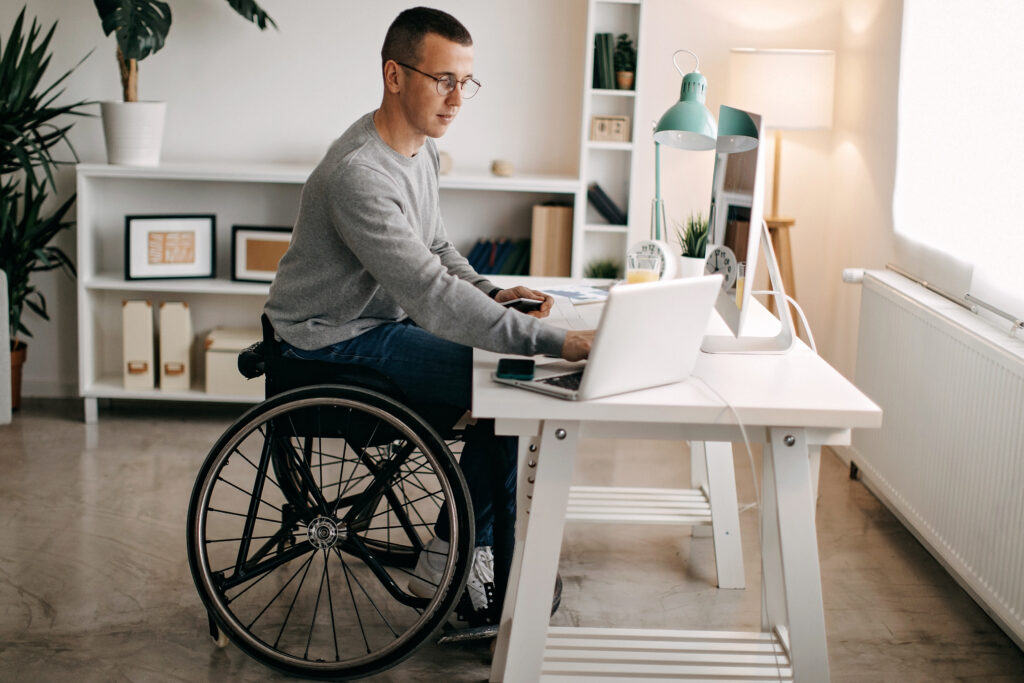 Young man with disabilities working on his stock market portfolio