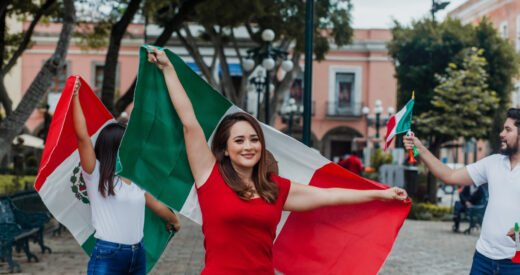 Proud mexican woman holding a flag of Mexico