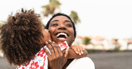 Jamaican mother and son embracing