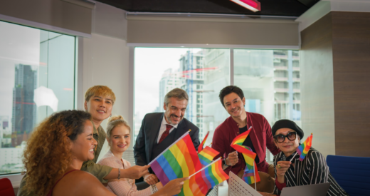 Business people holding pride flags stock photo