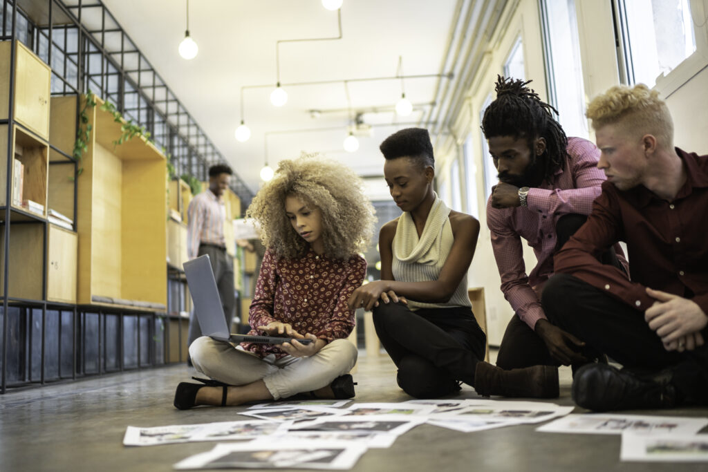 Business team discussing some papers on the floor in the office