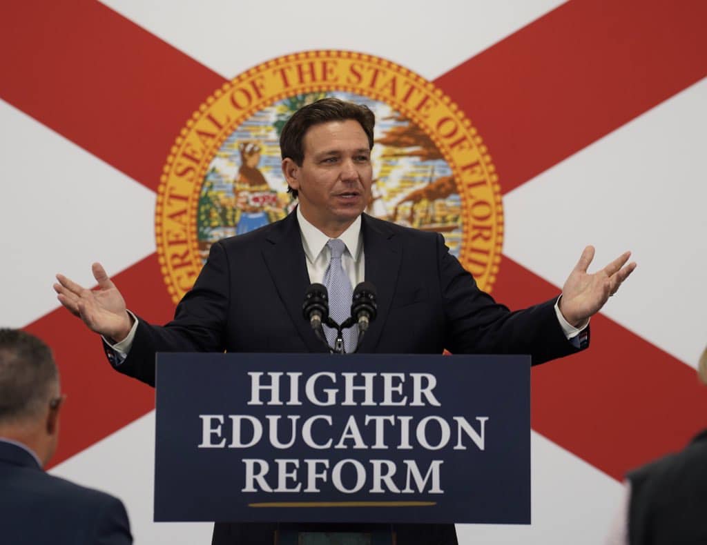 Ron DeSantis behind a higher education reform podium