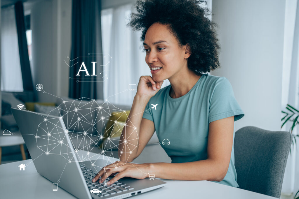 Happy young african-american woman using laptop at home. Human brain and artificial intelligence concept.