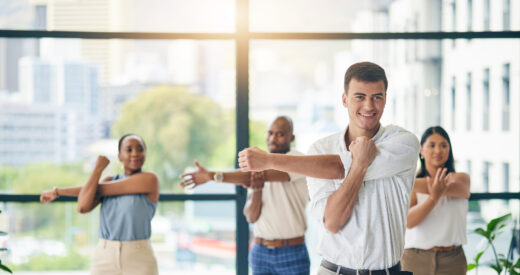 Workout, stretching and a group of business people in the office to exercise for health or mobility together. Fitness, wellness and coach training an employee team in the workplace for a warm up