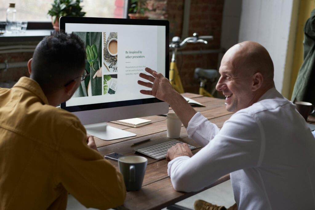 Coworkers collaborating in front of a computer screen