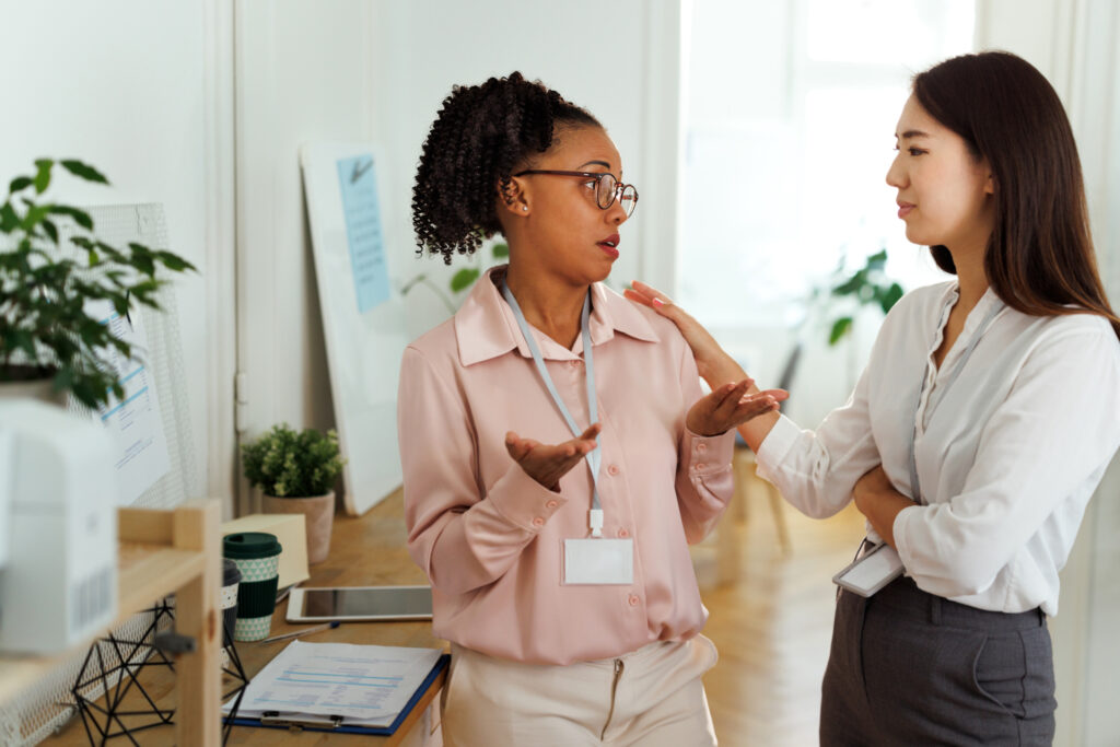 Woman consoling her colleague at the office