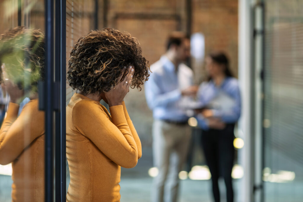 Photo of female Worker having headache. Dark-haired office worker having headache after been fired from work for no reason.