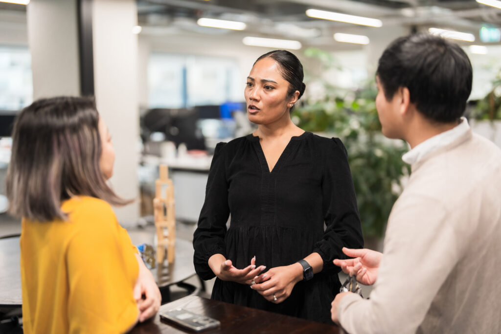 Business colleagues collaborating in a corporate office, brainstorming and planning strategies to drive company goals and success.