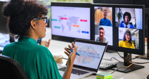 Woman trainer leads workshop with remote workers team in video call, back side view